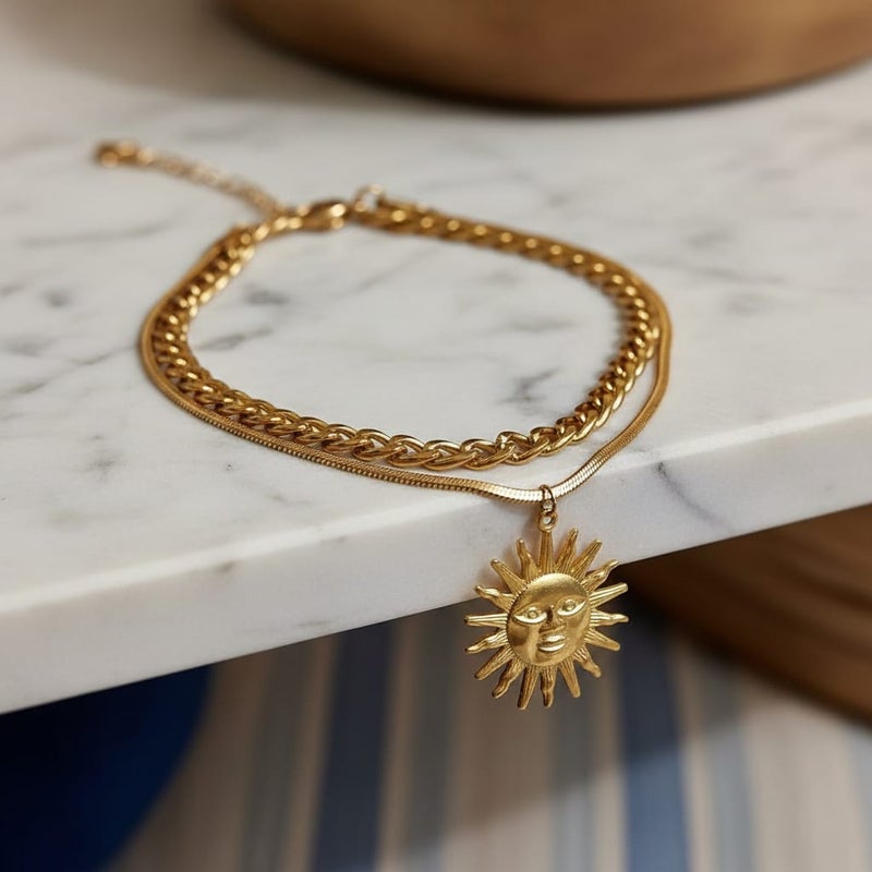 An elegant gold bracelet made of rust-resistant stainless steel, with a double design combining a wide chain and a smooth chain with an attractive sun pendant, with an adjustable clasp to suit you. - Image 3